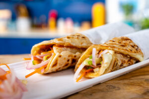 Two delicious stuffed egg flatbreads on plate